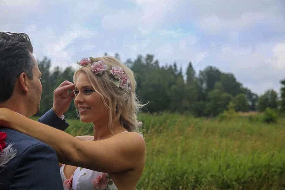 A bride and groom meeting out in the countryside