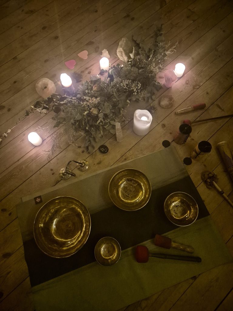 Singing bowls, candles and flowers prepared for sound healing